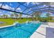 Sparkling screened-in pool and spa featuring manicured landscaping and sunny skies at 16606 Barnwood Pl, Lakewood Ranch, FL 34211