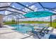 Gorgeous pool and spa with fountains providing picturesque lake views, complemented by shaded lounge area at 16606 Barnwood Pl, Lakewood Ranch, FL 34211
