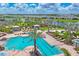 Resort-style community pool with lounge chairs, palm trees, and cabanas overlooks the lake at 16606 Barnwood Pl, Lakewood Ranch, FL 34211