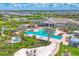 Community amenities include a pool, spa, lounge seating, and tropical landscaping by the clubhouse at 16606 Barnwood Pl, Lakewood Ranch, FL 34211
