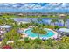 Aerial view of a unique community pool with lounge seating and a tropical island theme at 16606 Barnwood Pl, Lakewood Ranch, FL 34211