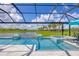 Stunning pool and spa with fountains overlooking serene water views, perfect for relaxation and entertainment at 16606 Barnwood Pl, Lakewood Ranch, FL 34211