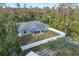 Aerial view of the home and backyard with a privacy fence at 17113 Malta Ave, Port Charlotte, FL 33954