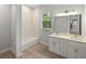 Bathroom featuring a double sink vanity, tiled shower and floors at 17113 Malta Ave, Port Charlotte, FL 33954