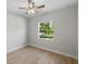 Bedroom features stylish flooring, a ceiling fan, and a view of the outdoors at 17113 Malta Ave, Port Charlotte, FL 33954