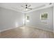 Spacious bedroom featuring two windows, tile floors, ceiling fan, and plenty of natural light at 17113 Malta Ave, Port Charlotte, FL 33954