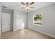 Bright bedroom with wood-look floors, ceiling fan, and closet at 17113 Malta Ave, Port Charlotte, FL 33954
