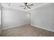 A spacious bedroom with a tile floor and ceiling fan at 17113 Malta Ave, Port Charlotte, FL 33954