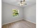 Bright bedroom featuring natural light, ceiling fan and hard surface floors at 17113 Malta Ave, Port Charlotte, FL 33954