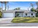 Charming single-story home with a manicured lawn, paved driveway, and an attached two-car garage at 17113 Malta Ave, Port Charlotte, FL 33954