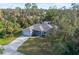 Charming single-story home with an attached garage, patterned driveway and a lush green yard at 17113 Malta Ave, Port Charlotte, FL 33954