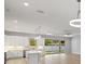 Modern kitchen with stainless steel appliances, a center island, and stylish pendant lighting at 17113 Malta Ave, Port Charlotte, FL 33954