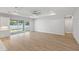 Bright living space with sliding glass doors to the backyard and a view of the modern, open-concept kitchen at 17113 Malta Ave, Port Charlotte, FL 33954
