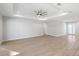 Expansive living space with wood-look tile floors, tray ceilings, and a doorway leading to other rooms at 17113 Malta Ave, Port Charlotte, FL 33954