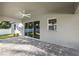 Back patio with ceiling fan and stone flooring at 17113 Malta Ave, Port Charlotte, FL 33954
