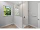 Modern shower boasts tile and glass enclosure with a window and stainless fixtures at 17113 Malta Ave, Port Charlotte, FL 33954