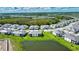 Scenic aerial view of a community with picturesque lakes, modern houses, and lush green landscapes at 17715 Boracay Ct # 202, Venice, FL 34293