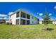Expansive backyard featuring a serene pond view, two-story construction, and manicured lawn at 17715 Boracay Ct # 202, Venice, FL 34293