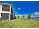 Home exterior with a view of a beautiful backyard, screened lanai, and serene pond at 17715 Boracay Ct # 202, Venice, FL 34293