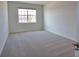 Bright bedroom featuring plush carpeting and a window offering natural light at 17715 Boracay Ct # 202, Venice, FL 34293
