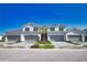 Stylish townhomes featuring gray roofs, attached garages, and landscaped lawns under a clear blue sky at 17715 Boracay Ct # 202, Venice, FL 34293