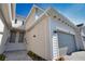 A modern townhome exterior with stairs to the front doors and a gray garage door at 17715 Boracay Ct # 202, Venice, FL 34293