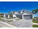Modern townhomes boast a gray garage door, clean lines, and neat landscaping under a clear blue sky at 17715 Boracay Ct # 202, Venice, FL 34293