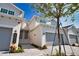 Modern townhome exterior with two doors, garage access, clean landscaping, and blue sky at 17715 Boracay Ct # 202, Venice, FL 34293