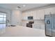 Well-lit kitchen features white cabinets, stainless steel appliances, and a large countertop island at 17715 Boracay Ct # 202, Venice, FL 34293