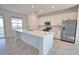 Spacious kitchen with a large island, stainless steel appliances, and bright, natural light at 17715 Boracay Ct # 202, Venice, FL 34293