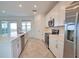 Bright, spacious kitchen with a large island, stainless steel appliances, and lovely outdoor view at 17715 Boracay Ct # 202, Venice, FL 34293