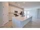 Modern kitchen features stainless steel appliances, island with white quartz countertops, and lots of light at 17715 Boracay Ct # 202, Venice, FL 34293