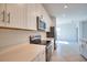 Modern kitchen featuring stainless steel appliances, stone countertops, and white cabinetry at 17715 Boracay Ct # 202, Venice, FL 34293