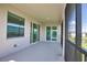 Relax on this peaceful lanai, featuring seamless access to the indoors through sliding glass doors at 17715 Boracay Ct # 202, Venice, FL 34293