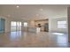 Spacious open-concept living area with tile floors, kitchen island, and sliding glass doors to the balcony at 17715 Boracay Ct # 202, Venice, FL 34293
