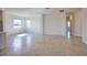 Open-concept living room featuring tile flooring and abundant natural light from multiple windows at 17715 Boracay Ct # 202, Venice, FL 34293