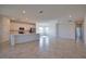 Bright, open-concept living space with large tile floors leading into kitchen area, ample natural light at 17715 Boracay Ct # 202, Venice, FL 34293