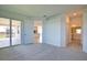 Open bedroom with sliding glass doors to outdoor patio, connecting indoor and outdoor spaces at 17715 Boracay Ct # 202, Venice, FL 34293