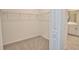 Walk-in closet with ample storage space and wire shelving, next to the bathroom at 17715 Boracay Ct # 202, Venice, FL 34293