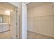 Walk-in closet with wire shelves, positioned near the bright and modern bathroom at 17715 Boracay Ct # 202, Venice, FL 34293