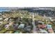Aerial view of a home with a private pool along a tree lined street with views of the bay and city at 1774 Cherokee Dr, Sarasota, FL 34239