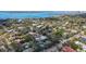 A picturesque aerial view of a home nestled in a lush, green neighborhood with a private pool and bay views at 1774 Cherokee Dr, Sarasota, FL 34239