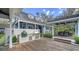 Spacious backyard with a built-in grill, brick accents, and a wooden deck for entertaining at 1774 Cherokee Dr, Sarasota, FL 34239