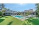 Expansive backyard featuring a sparkling pool, outdoor seating, and lush green lawn at 1774 Cherokee Dr, Sarasota, FL 34239
