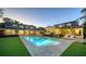 Expansive backyard featuring a sparkling pool, lush lawn, and ample seating areas for relaxation and entertainment at 1774 Cherokee Dr, Sarasota, FL 34239
