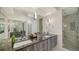 Modern bathroom with dual sinks, marble countertops, and a glass-enclosed shower at 1774 Cherokee Dr, Sarasota, FL 34239