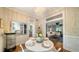 Charming dining room with hardwood floors, modern chandelier, and views to the living spaces at 1774 Cherokee Dr, Sarasota, FL 34239