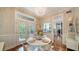 Bright dining area featuring hardwood floors, chic lighting, and easy access to the outdoors at 1774 Cherokee Dr, Sarasota, FL 34239