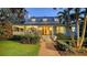 Charming two-story home with a brick walkway, manicured landscaping, and inviting front porch at 1774 Cherokee Dr, Sarasota, FL 34239