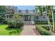 Inviting two-story home with lush landscaping, a brick walkway and classic architectural details at 1774 Cherokee Dr, Sarasota, FL 34239